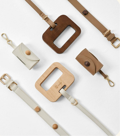 A product presentation of the Knotia brand's leather and wood accessory straps, featuring multiple flat-lay views of straps in brown, beige, and light wood tones with gold-toned hardware, set against a warm cream background with Chinese text.